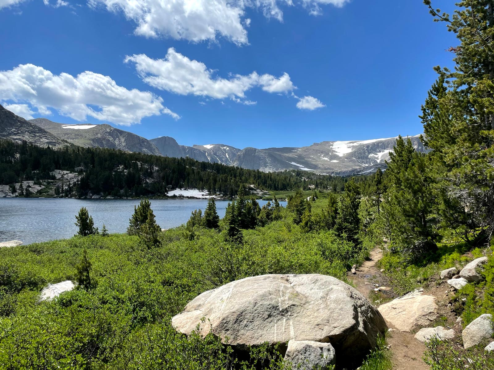 A lake with snow-capped mountains surrounding