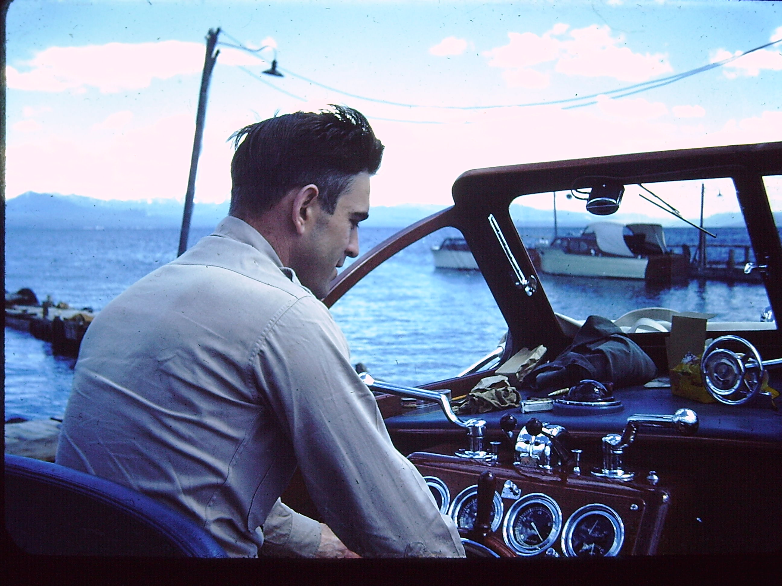 My grandfather piloting a boat