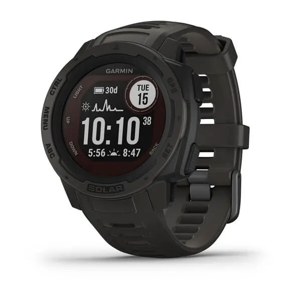 Gray and black Garmin Instinct watch sitting sideways on a wooden surface reading Tue 15 10:10, and the words on the dial reading ctrl, menu, abc, solar, gps, and set